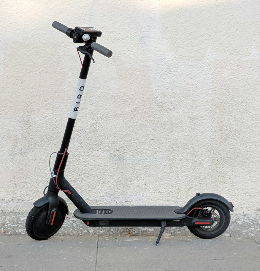 An e-scooter with a light-coloured background